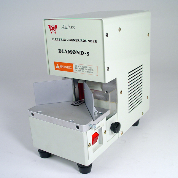 The Diamond-5 industrial electric corner rounding equipment, featuring a warning label, is set against a white background.